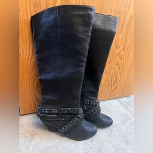 Tall black studded black boots